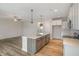 Modern kitchen with island, stainless steel appliances, and light wood flooring at 54 Barony Ln, Smithfield, NC 27577