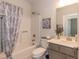 Full bath features a shower and tub combo with neutral fixtures and a patterned shower curtain at 55 Streamline Ct, Lillington, NC 27546