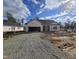 New construction home with a gravel driveway and landscaping at 55 Streamline Ct, Lillington, NC 27546