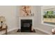 Elegant fireplace with mantle, art, and decor adds style to this cozy living space at 55 Streamline Ct, Lillington, NC 27546