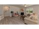 Cozy living room featuring a fireplace, ceiling fan, luxury vinyl floors and lots of natural light at 55 Streamline Ct, Lillington, NC 27546