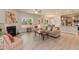 Open concept living space featuring luxury vinyl floors, a fireplace, and a modern kitchen at 55 Streamline Ct, Lillington, NC 27546