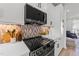 Stainless steel range and LG microwave in a kitchen with backsplash at 710 W North St # 103, Raleigh, NC 27603