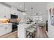 Bright, open kitchen with stainless steel appliances, a quartz island, and barstool seating at 710 W North St # 103, Raleigh, NC 27603