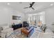 Cozy living room with a ceiling fan, board and batten accent wall, and balcony access at 710 W North St # 103, Raleigh, NC 27603