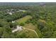 Spacious land features lush trees, green pastures, and estate buildings at 1021 Dimmocks Mill Rd, Hillsborough, NC 27278