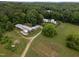 Overhead image of an estate with well-maintained buildings, gardens, and surrounding foliage at 1021 Dimmocks Mill Rd, Hillsborough, NC 27278