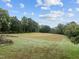 Large, grassy backyard featuring mature trees at 1021 Dimmocks Mill Rd, Hillsborough, NC 27278