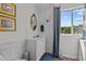 Well-lit bathroom with white vanity, decorative mirror, and stylish blue accents creating a fresh ambiance at 1021 Dimmocks Mill Rd, Hillsborough, NC 27278
