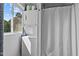 Compact laundry area featuring a stacked washer and dryer, maximizing space and convenience in the bathroom at 1021 Dimmocks Mill Rd, Hillsborough, NC 27278