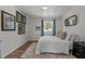 Cozy bedroom with white walls, plush carpet, and window providing natural light at 1021 Dimmocks Mill Rd, Hillsborough, NC 27278