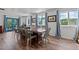 Large dining room featuring a long table, windows, and blue curtains at 1021 Dimmocks Mill Rd, Hillsborough, NC 27278
