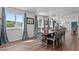 Bright dining area boasts a large table, wood flooring, and many windows with views at 1021 Dimmocks Mill Rd, Hillsborough, NC 27278