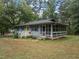 Quaint house featuring a screened-in porch and a neatly maintained yard, perfect for relaxed living at 1021 Dimmocks Mill Rd, Hillsborough, NC 27278