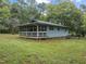 Cozy home with a spacious screened porch surrounded by a lush green lawn, ideal for outdoor enjoyment at 1021 Dimmocks Mill Rd, Hillsborough, NC 27278