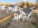 A high-angle shot displaying the house layout, yard, and neighborhood context with adjacent home at 1101 Ridge Rd, Roxboro, NC 27573