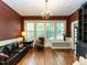 Spacious living room with hardwood floors, large windows, and built-in shelving at 1208 College Pl, Raleigh, NC 27605