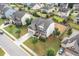 Aerial view of home with manicured lawn and mature trees in a neighborhood at 453 Granite Saddle Dr, Rolesville, NC 27571