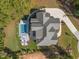 Aerial shot showcases a home with a pool, well-manicured landscaping, and a long driveway, nestled among mature trees at 60 Citori Ct, Pittsboro, NC 27312