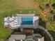 Aerial view of a modern rectangular pool featuring an outdoor fire pit and comfortable seating, surrounded by lush greenery at 60 Citori Ct, Pittsboro, NC 27312