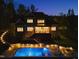 Back exterior view with a large pool, lighted stairs, deck and patio at 60 Citori Ct, Pittsboro, NC 27312