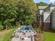 The backyard features an in-ground pool, patio with seating and lots of shade at 60 Citori Ct, Pittsboro, NC 27312