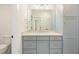 Modern bathroom with light gray shaker cabinets, quartz countertops, and stainless steel hardware at 60 Citori Ct, Pittsboro, NC 27312