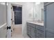 Bathroom with gray cabinets, quartz countertop, and a navy herringbone tile shower at 60 Citori Ct, Pittsboro, NC 27312