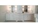 Bathroom featuring double sinks, white cabinetry, and elegant lighting at 60 Citori Ct, Pittsboro, NC 27312