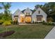 Charming white brick home featuring a landscaped front yard and inviting front porch at 60 Citori Ct, Pittsboro, NC 27312