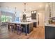 Modern kitchen with dark cabinetry, a large island with seating, and stainless steel appliances at 60 Citori Ct, Pittsboro, NC 27312