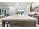 Open concept kitchen with stainless steel appliances, an island with seating, and modern lighting at 60 Citori Ct, Pittsboro, NC 27312