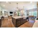 Spacious kitchen with an island, modern appliances, and an open view into the living and dining areas at 60 Citori Ct, Pittsboro, NC 27312