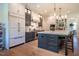 Spacious kitchen with stainless steel appliances, an island with seating, and custom cabinets at 60 Citori Ct, Pittsboro, NC 27312