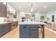 Open concept kitchen with stainless steel appliances, an island with seating, and hardwood floors at 60 Citori Ct, Pittsboro, NC 27312