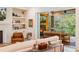 Comfortable living room with fireplace, built-in shelving, and decor, connecting to an outdoor living area at 60 Citori Ct, Pittsboro, NC 27312