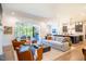 Stylish open-concept living room with outdoor access and views of the kitchen and dining area at 60 Citori Ct, Pittsboro, NC 27312