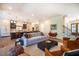 Open-concept living room with hardwood floors, connecting to a modern kitchen and a bright staircase at 60 Citori Ct, Pittsboro, NC 27312