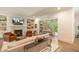 Bright living room with fireplace, built-in shelving, and sliding glass doors to an outdoor living space at 60 Citori Ct, Pittsboro, NC 27312