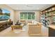 Bright living room featuring bookshelves, TV, comfortable seating, and natural light at 60 Citori Ct, Pittsboro, NC 27312