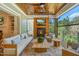 Inviting outdoor living area with wood ceiling, fireplace, comfortable seating, and view of greenery at 60 Citori Ct, Pittsboro, NC 27312