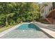 Beautiful in-ground pool with a stone deck and manicured landscaping in the backyard at 60 Citori Ct, Pittsboro, NC 27312