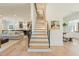 Elegant staircase with light wood treads, black railings, and open floor plan at 60 Citori Ct, Pittsboro, NC 27312