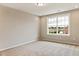 Bright bedroom featuring carpeted floor and a large window at 1055 Fairhaven Dr # 56, Mebane, NC 27302