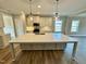 Modern kitchen with large island and quartz countertops at 1055 Fairhaven Dr # 56, Mebane, NC 27302