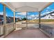 Relaxing screened porch with a view of the neighborhood and a partially wooded area at 1055 Fairhaven Dr # 56, Mebane, NC 27302