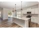 Modern kitchen with white cabinets, quartz countertops and stainless steel appliances at 224 Trescott St, Smithfield, NC 27577