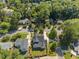 Aerial view of home surrounded by lush green trees, a manicured lawn, and other homes at 701 Dartmouth Rd, Raleigh, NC 27609