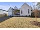 Expansive backyard view of a modern home, featuring a covered patio, lush lawn, and a privacy fence for serene outdoor living at 701 Dartmouth Rd, Raleigh, NC 27609