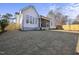 Expansive backyard view of a modern home, featuring a covered patio, lush lawn, and a privacy fence for serene outdoor living at 701 Dartmouth Rd, Raleigh, NC 27609